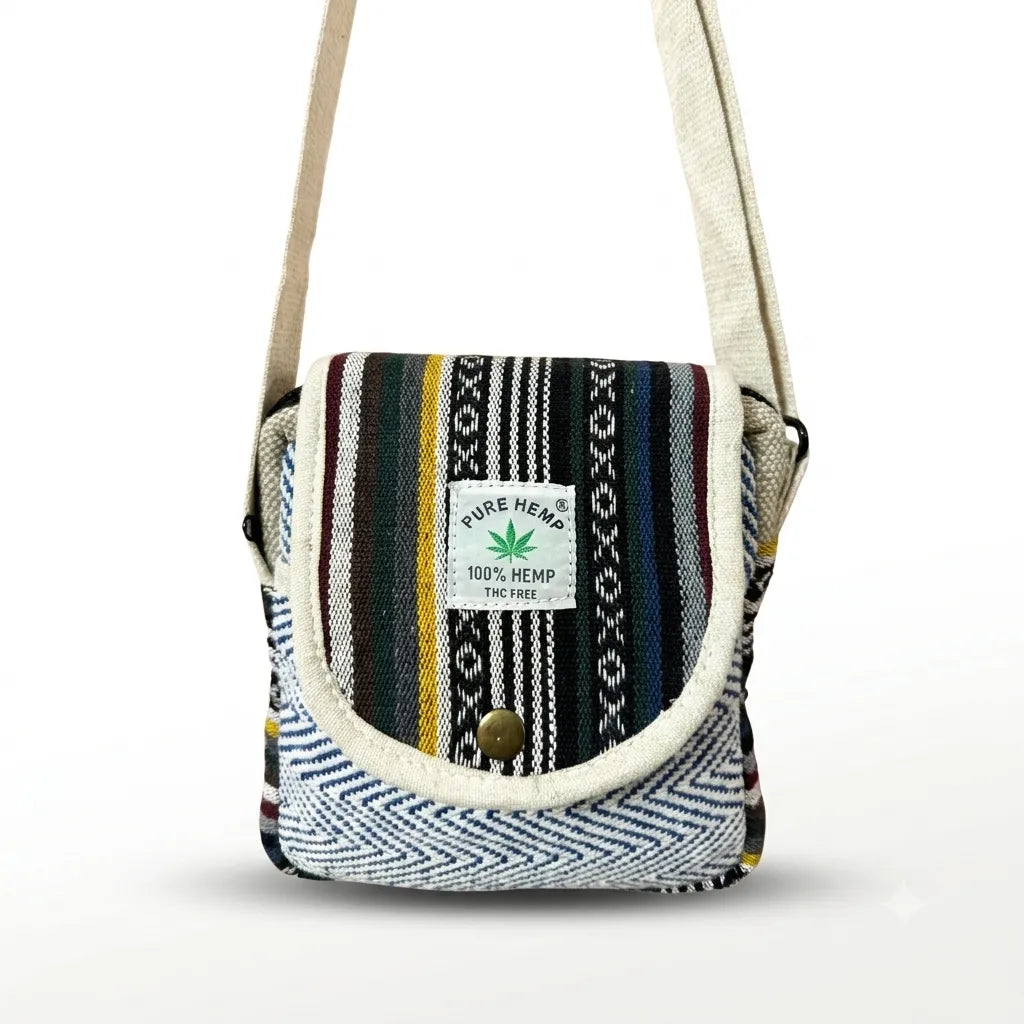 Khojo Yatra flap hemp sling bag, front view, rounded beige-piped flap with multicolour woven stripes and blue-and-white chevron front pocket