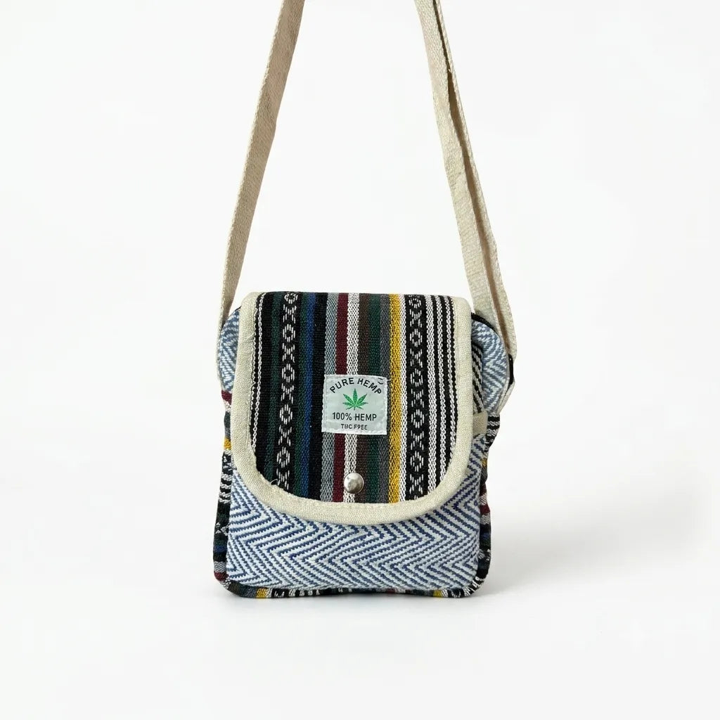 Side of the Khojo Yatra hemp sling bag showing rounded corners, beige piping and multicolour woven striped panels