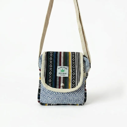 Side of the Khojo Yatra hemp sling bag showing rounded corners, beige piping and multicolour woven striped panels